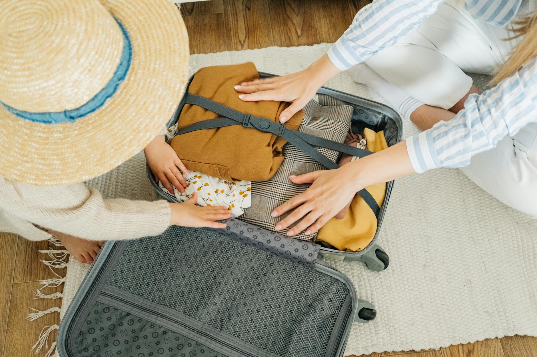 women packing clothes in a suitcase